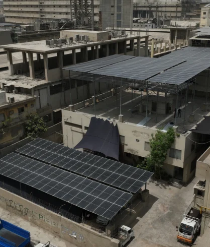 Solar panels beside rooftop structures at Ahmed Textile
