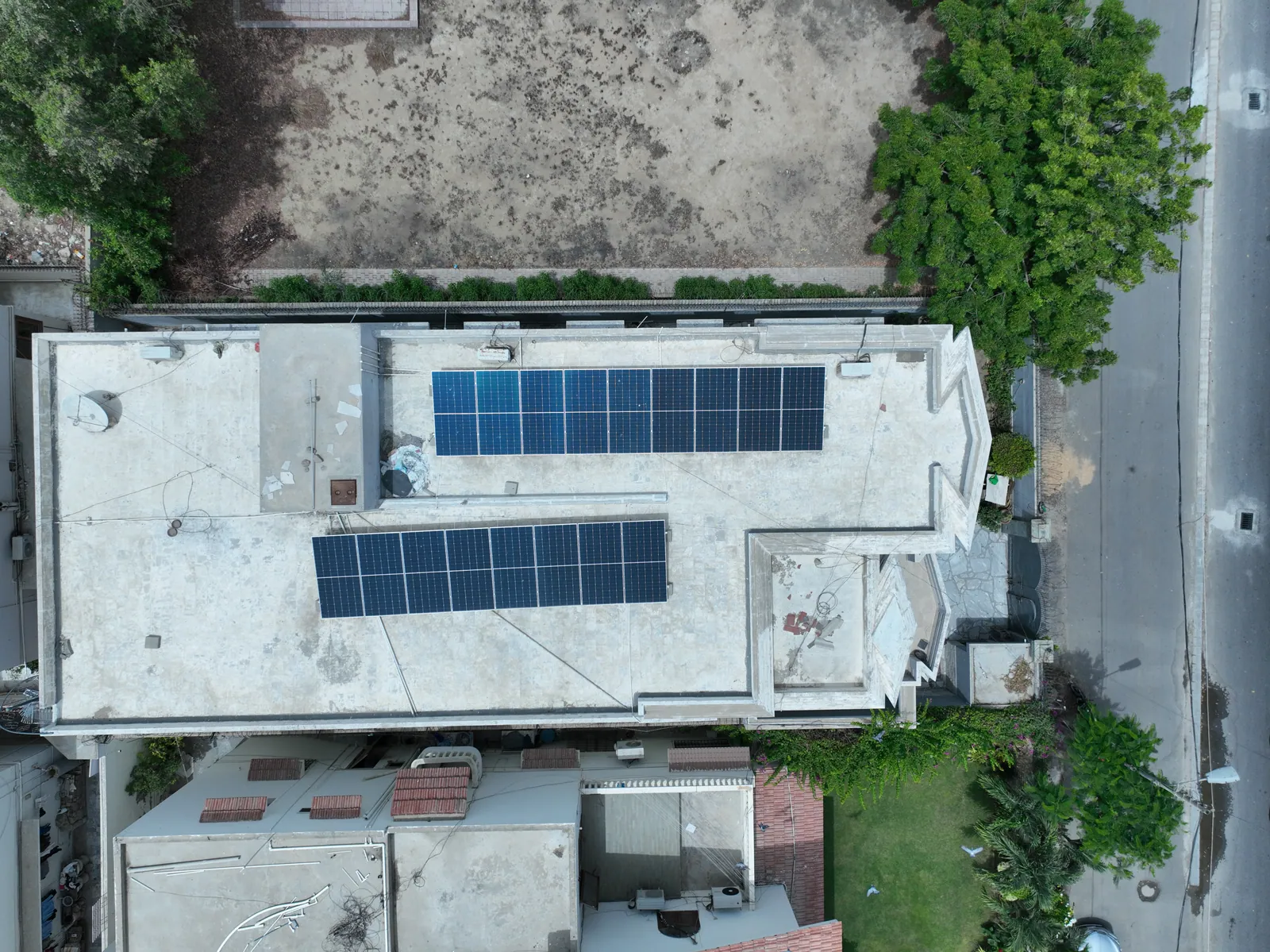 Overhead view of two solar panel rows fitted within a home's rooftop
